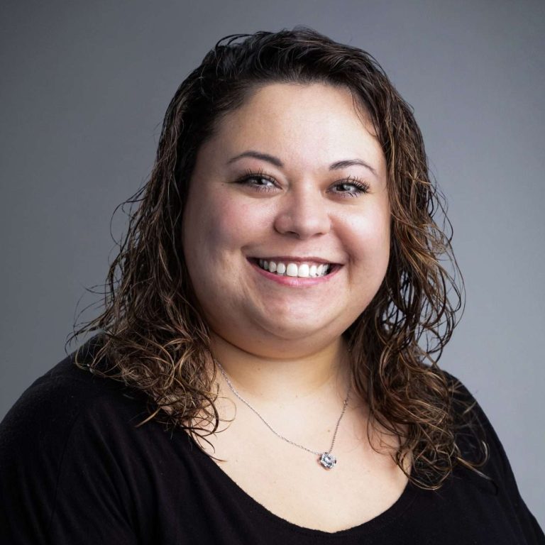 Jordana Oseto, DNP, APRN, is smiling for her headshot.